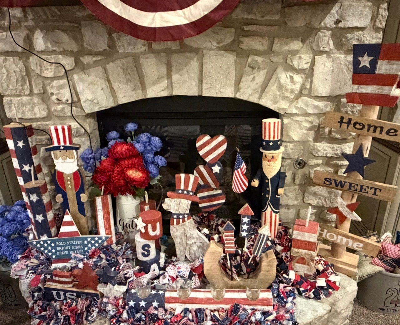 Patriotic fireplace mantel display with Uncle Sam figures and Americana decor