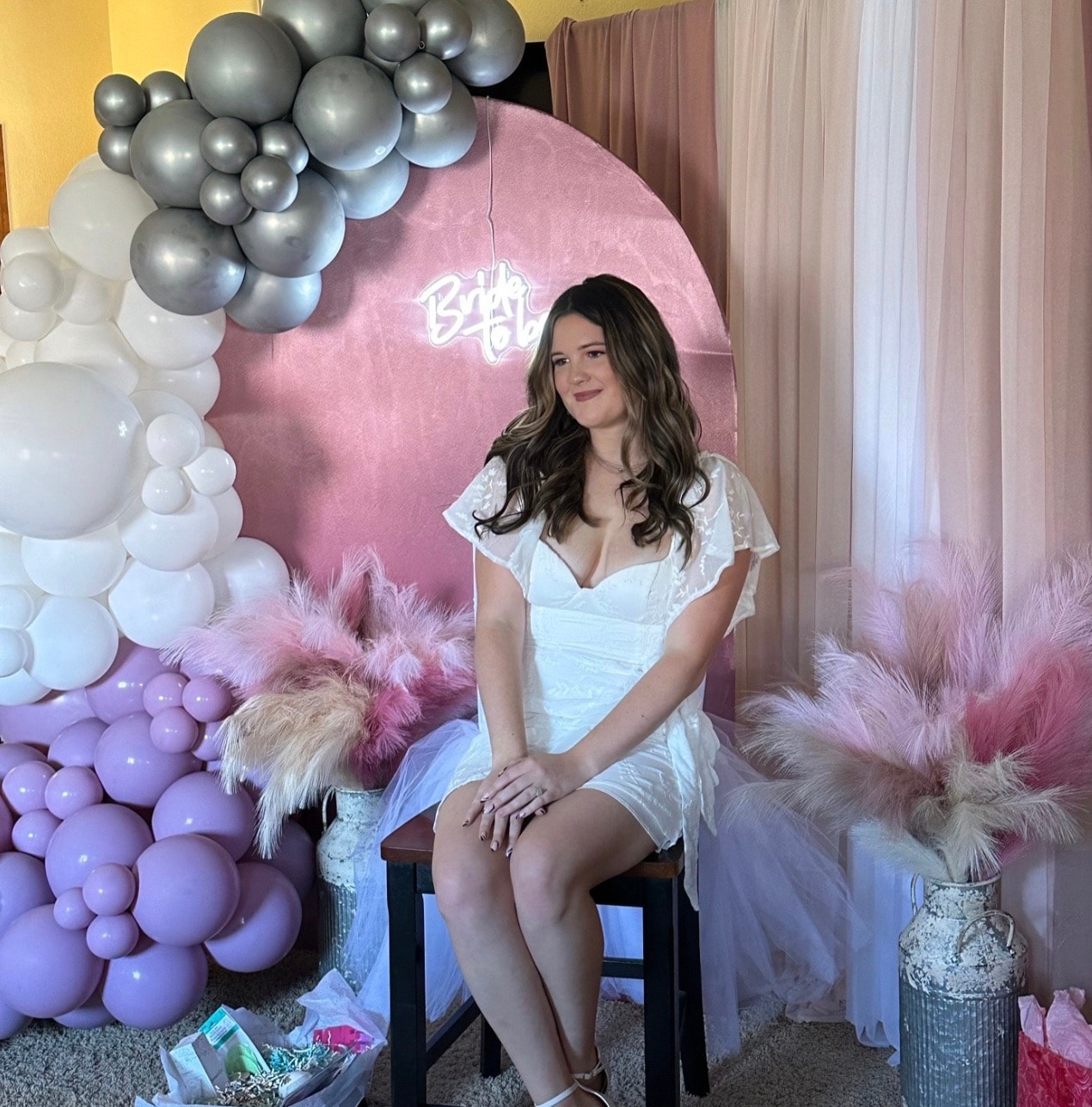 Bridal shower balloon arch and neon sign setup