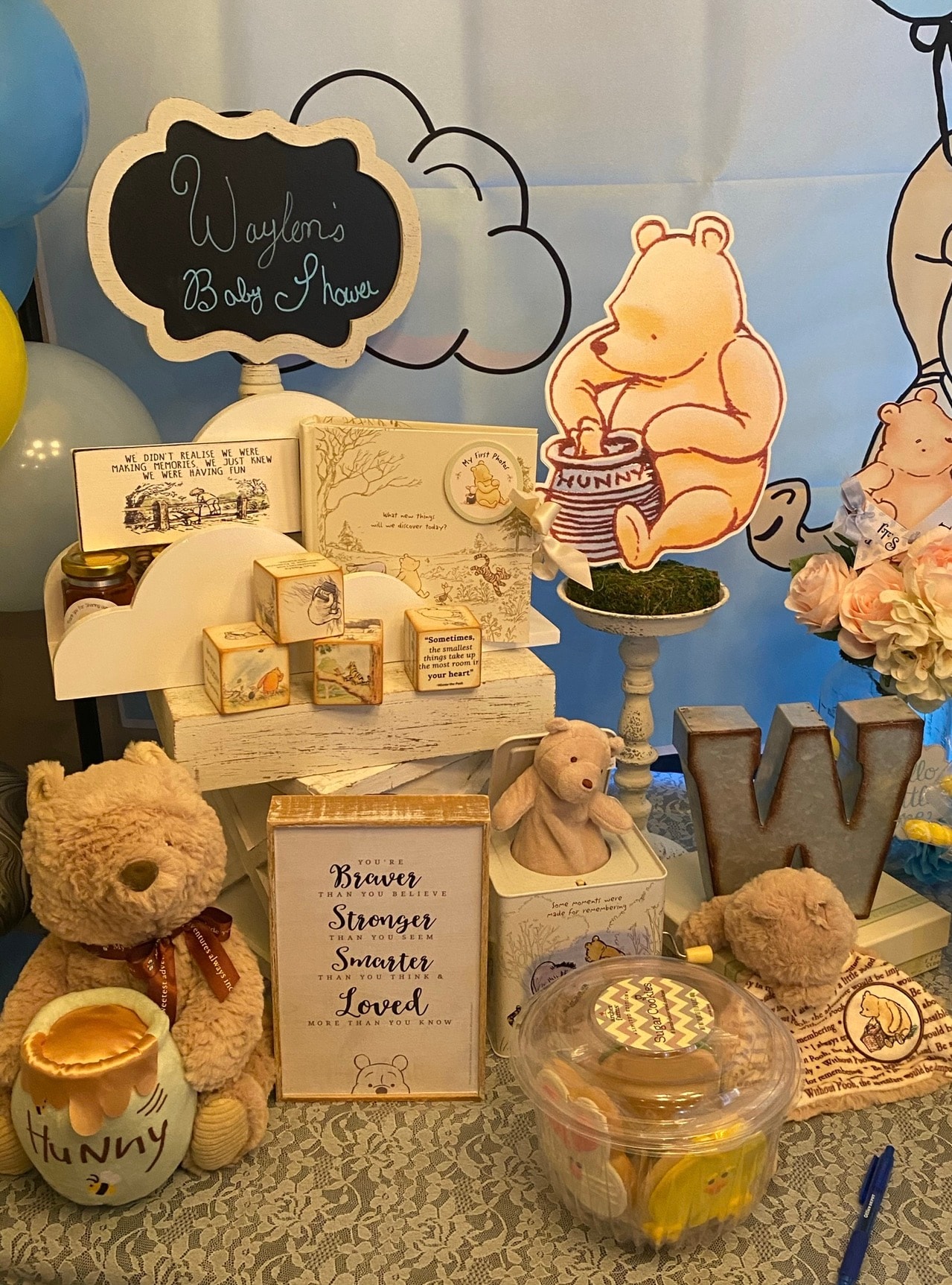 Winnie the Pooh baby shower display with plush toys and keepsake blocks