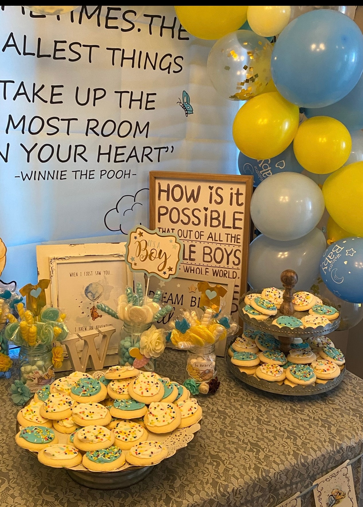 Winnie the Pooh baby shower with balloon arch and decorated cookies